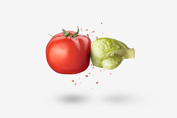 Image showing Organic cabbage as a boxing glove is hitting red tomato vegetable.