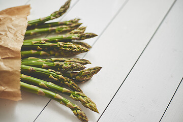 Image showing Fresh green asparagus in a brown paper bag. Healthy eating concept. Food for vegetarians