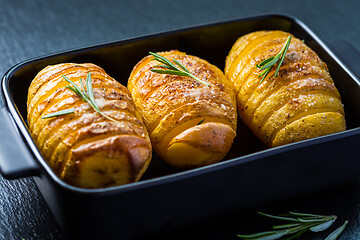 Image showing Hasselback potatoes. Backed potatoes from Sweden with garlic and herbs