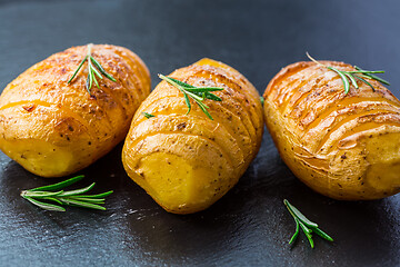 Image showing Hasselback potatoes. Backed potatoes from Sweden with garlic and herbs