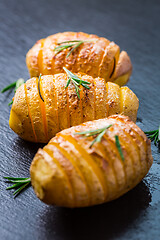 Image showing Hasselback potatoes. Backed potatoes from Sweden with garlic and herbs