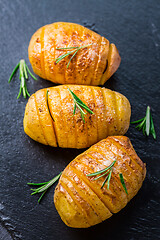 Image showing Hasselback potatoes. Backed potatoes from Sweden with garlic and herbs