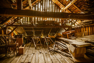 Image showing Interior of old wooden shed with scrap wood with sunrays 