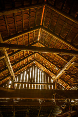 Image showing Interior of old wooden shed with scrap wood with sunrays 