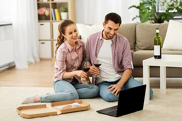 Image showing happy couple with laptop drinking red wine at home