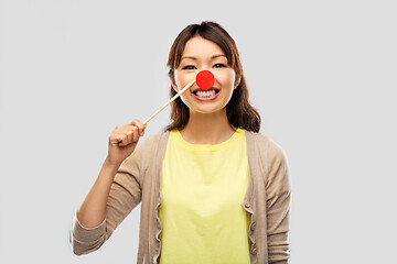 Image showing happy asian woman with red clown nose