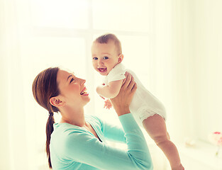 Image showing happy young mother with little baby at home