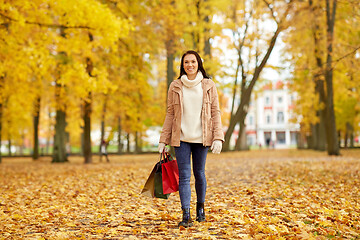 Image showing woman with shopping bags in autumn park