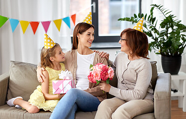 Image showing daughter with gift box greeting mother on birthday