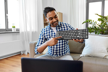 Image showing male blogger with keyboard videoblogging at home