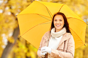 Image showing happy woman with umbrella in autumn park
