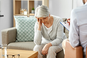 Image showing sad senior woman patient and psychologist