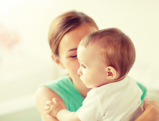 Image showing happy young mother with little baby at home