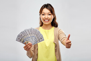 Image showing asian woman with dollar money showing thumbs