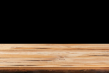 Image showing Retro wooden table on a black background can used for display or montage your products.