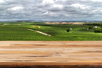 Image showing Retro wooden table on a natural countryside background for display or montage your products.