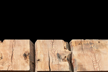 Image showing Retro rough wooden table for display or montage your products on a black background.