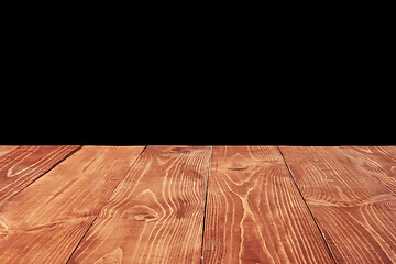 Image showing Aged natural wooden table for montage and present your products on a black background.