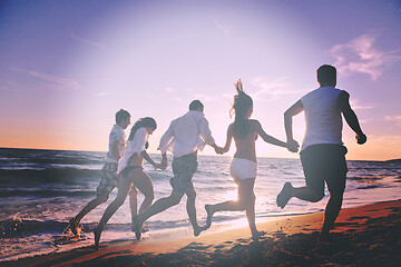 Image showing people group running on the beach