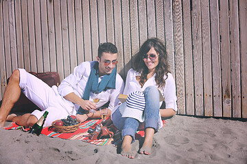 Image showing young couple enjoying  picnic on the beach