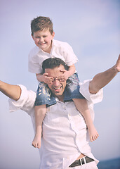 Image showing happy father and son have fun and enjoy time on beach