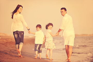 Image showing happy young family have fun on beach