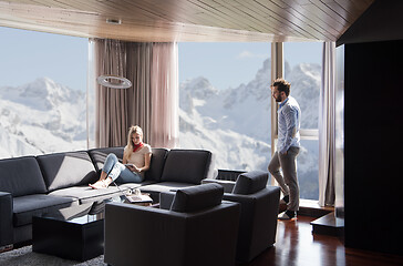 Image showing couple relaxing at  home using tablet computer