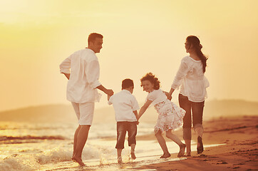 Image showing happy young family have fun on beach at sunset