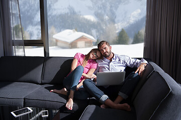 Image showing couple relaxing at  home using laptop computers