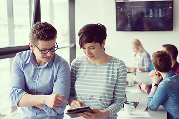 Image showing Two Business People Working With Tablet in office