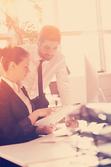 Image showing business couple working together on project, sunrise in backgrou