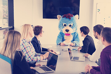 Image showing boss dresed as bear having fun with business people in trendy of