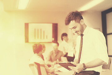 Image showing young business man with tablet at office meeting room