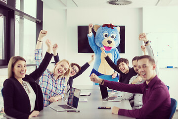 Image showing boss dresed as bear having fun with business people in trendy of