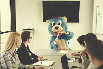 Image showing boss dresed as bear having fun with business people in trendy of