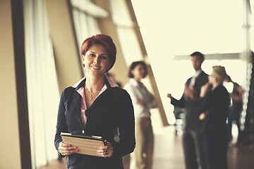 Image showing business woman  at office with tablet  in front  as team leader