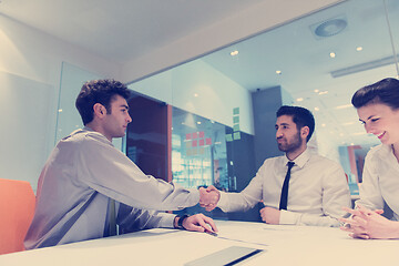 Image showing young couple signing contract documents on partners back