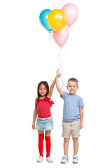 Image showing Full length portrait of cute little kids in stylish clothes looking at camera and smiling