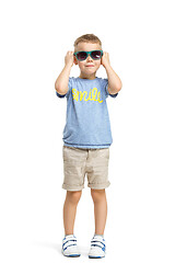 Image showing Full length portrait of cute little kid in stylish clothes looking at camera and smiling