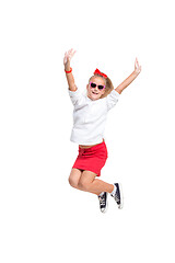 Image showing Cute little girl jump. Studio shot. White background