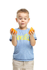 Image showing Full length portrait of cute little kid in stylish clothes with orange