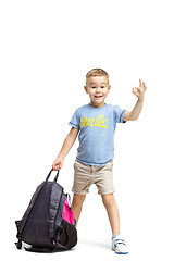 Image showing Full length portrait of cute little kid in stylish clothes looking at camera and smiling