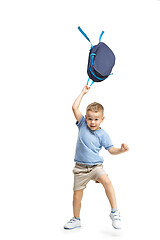 Image showing Full length portrait of cute little kid in stylish clothes jumping with bag