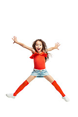 Image showing Cute little girl jump. Studio shot. White background