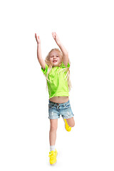 Image showing Cute little girl jump. Studio shot. White background