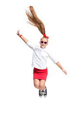 Image showing Cute little girl jump. Studio shot. White background