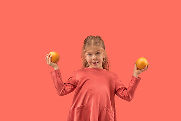 Image showing Cute little girl in coral dress with long hair smiling to camera