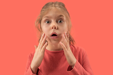 Image showing Cute little surprised girl in coral dress with long hair smiling to camera