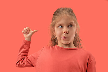 Image showing Cute little surprised girl in coral dress with long hair smiling to camera