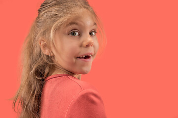 Image showing Cute little girl in coral dress with long hair smiling to camera